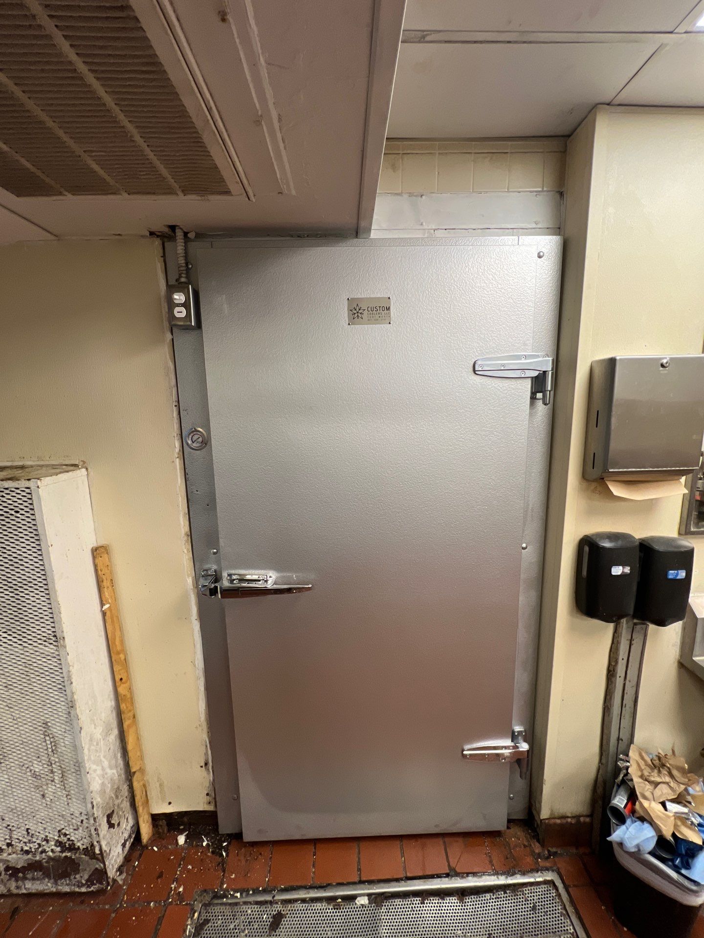 Replacement walk-in cooler door installed in a commercial kitchen